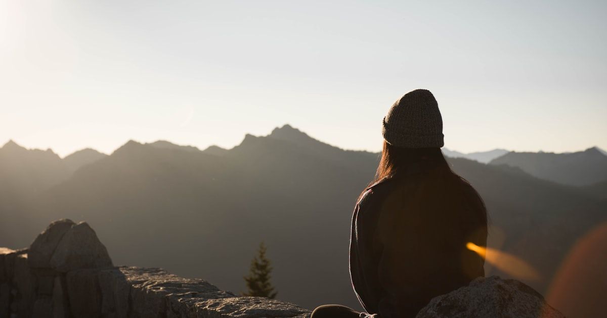 Person in quiet contemplation in a peaceful setting